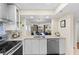 Bright and airy kitchen overlooking the dining and living area, featuring stainless steel appliances at 201 W Laurel St # 702, Tampa, FL 33602