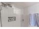 Shower with modern fixtures, built-in shelving, and textured tile at 201 W Laurel St # 702, Tampa, FL 33602