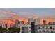 An elevated view from an apartment showcasing the city skyline during a colorful sunset at 201 W Laurel St # 702, Tampa, FL 33602