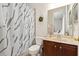 Bathroom with a white patterned shower curtain and wood vanity at 21654 Draycott Way, Land O Lakes, FL 34637