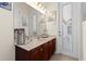 Bathroom with a double door leading outside and a dark wood vanity at 21654 Draycott Way, Land O Lakes, FL 34637