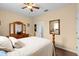 Comfortable bedroom with a ceiling fan, wood floors, and light colored walls at 21654 Draycott Way, Land O Lakes, FL 34637