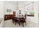 Formal dining room with elegant chandelier, stylish furniture, and archway views to the kitchen and living room at 21654 Draycott Way, Land O Lakes, FL 34637