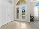 Bright foyer with tiled floors, double front doors with decorative glass, and a closet at 21654 Draycott Way, Land O Lakes, FL 34637
