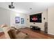 Home theater room with a projector, screen, hardwood floors, and reclining seats at 21654 Draycott Way, Land O Lakes, FL 34637