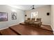 Home theater room with a projector, screen, hardwood floors, and reclining seats at 21654 Draycott Way, Land O Lakes, FL 34637