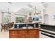 Open kitchen and living area featuring dark countertops, wood cabinets, and backyard pool view at 21654 Draycott Way, Land O Lakes, FL 34637