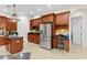 Kitchen featuring stainless steel appliances, wood cabinetry, tiled backsplash and adjacent desk at 21654 Draycott Way, Land O Lakes, FL 34637