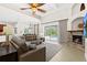 Spacious living room featuring a fireplace, high ceilings, and sliding glass doors to the pool area at 21654 Draycott Way, Land O Lakes, FL 34637
