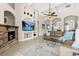 Bright living room boasts a stone fireplace, decorative arches, and a ceiling fan for added comfort at 21654 Draycott Way, Land O Lakes, FL 34637