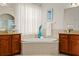This main bathroom has dual vanities, a soaking tub, and stylish decor, creating a relaxing atmosphere at 21654 Draycott Way, Land O Lakes, FL 34637