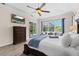 A view of the main bedroom showcases a large window, a pool view, and a modern television on the wall at 21654 Draycott Way, Land O Lakes, FL 34637