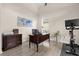 The office has neutral colored walls, dark wood furniture, and a Peloton exercise bike at 21654 Draycott Way, Land O Lakes, FL 34637
