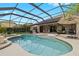 Sparkling screened pool with patio, lounge chairs, BBQ grill, verdant landscaping offering a private retreat at 21654 Draycott Way, Land O Lakes, FL 34637