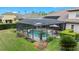 Enclosed screened pool and spa with lush landscaping, creating a private and relaxing backyard oasis at 21654 Draycott Way, Land O Lakes, FL 34637