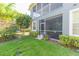 Well-maintained backyard featuring lush green grass and a screened-in patio for relaxed outdoor living at 2211 Kings Palace Dr, Riverview, FL 33578