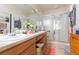 Well-lit bathroom featuring a double vanity and glass shower doors for easy maintenance at 2211 Kings Palace Dr, Riverview, FL 33578
