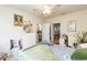 Well-lit bedroom featuring an ensuite bath, desk area, ceiling fan, and vibrant decor at 2211 Kings Palace Dr, Riverview, FL 33578