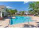 Inviting community pool surrounded by lounge chairs and lush greenery, offering a relaxing atmosphere at 2211 Kings Palace Dr, Riverview, FL 33578