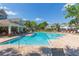 Community pool with chairs, and lush landscaping, perfect for relaxation and socializing at 2211 Kings Palace Dr, Riverview, FL 33578