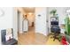 Hallway featuring hardwood floors, white walls, and natural light at 2211 Kings Palace Dr, Riverview, FL 33578