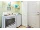 Functional laundry room with a white washer and dryer at 2211 Kings Palace Dr, Riverview, FL 33578