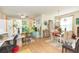 Bright living space featuring hardwood floors, plants, dining table, and a ceiling fan at 2211 Kings Palace Dr, Riverview, FL 33578