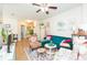 Bright living space features hardwood floors, a couch, and a ceiling fan at 2211 Kings Palace Dr, Riverview, FL 33578