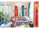 Comfortable living room with a sectional sofa, bright curtains, and decoratively arranged plants at 2211 Kings Palace Dr, Riverview, FL 33578