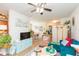 This living space features hardwood floors, a blue couch, and a television at 2211 Kings Palace Dr, Riverview, FL 33578