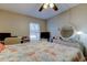 Bedroom with a window, computer desk, and a bed with a seashell patterned comforter at 225 Country Club Dr # 1104, Largo, FL 33771
