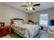 Bedroom with a ceiling fan, a bed with seashell patterned comforter, and a computer desk at 225 Country Club Dr # 1104, Largo, FL 33771
