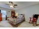 Cozy bedroom features a ceiling fan, comfortable bed, and a rocking chair at 225 Country Club Dr # 1104, Largo, FL 33771