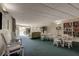 Large community room with ample seating, tables, and a bookcase at 225 Country Club Dr # 1104, Largo, FL 33771