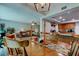 View of dining table flowing into living room and kitchen area at 225 Country Club Dr # 1104, Largo, FL 33771
