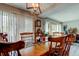 Bright dining area with wood table, chairs, and natural light from large windows at 225 Country Club Dr # 1104, Largo, FL 33771