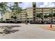 Multi-story condo building with a parking lot in front at 225 Country Club Dr # 1104, Largo, FL 33771