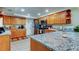 Well-lit kitchen featuring granite countertops and stainless steel appliances at 225 Country Club Dr # 1104, Largo, FL 33771