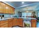 Open-concept kitchen and dining area with stainless steel dishwasher and granite countertops at 225 Country Club Dr # 1104, Largo, FL 33771