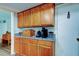 Kitchen area features light wood cabinetry, granite countertops, and ample storage space at 225 Country Club Dr # 1104, Largo, FL 33771