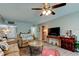 Open-concept living room with a ceiling fan, stylish furniture, and easy access to other rooms at 225 Country Club Dr # 1104, Largo, FL 33771