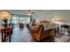 Inviting living room featuring sliding glass doors, a ceiling fan, and comfortable seating at 225 Country Club Dr # 1104, Largo, FL 33771