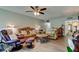 Inviting living room with comfortable seating, a ceiling fan, and view into other areas of the home at 225 Country Club Dr # 1104, Largo, FL 33771