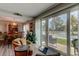 Warm living room with comfortable seating and views of the pool and landscaping beyond the sliding glass doors at 225 Country Club Dr # 1104, Largo, FL 33771