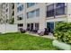 A private patio with seating, a grill, and lush green lawn offers outdoor living space at 225 Country Club Dr # 1104, Largo, FL 33771