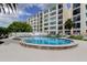 Community pool with condo building in the background at 225 Country Club Dr # 1104, Largo, FL 33771