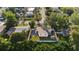 Aerial view of the home featuring a fenced-in backyard, a brick paver patio, lush green grass and a patio at 331 Barbara Cir, Belleair, FL 33756