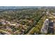 This aerial view shows the neighborhood and surrounding greenery near a walking path at 331 Barbara Cir, Belleair, FL 33756