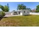 This spacious backyard features a patio, privacy fence, and mature landscaping at 331 Barbara Cir, Belleair, FL 33756
