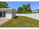 Spacious backyard featuring a well-maintained lawn and a tall white privacy fence at 331 Barbara Cir, Belleair, FL 33756